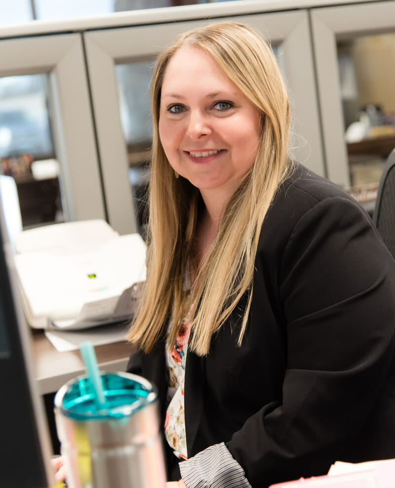 Laura Erdman sitting at her desk